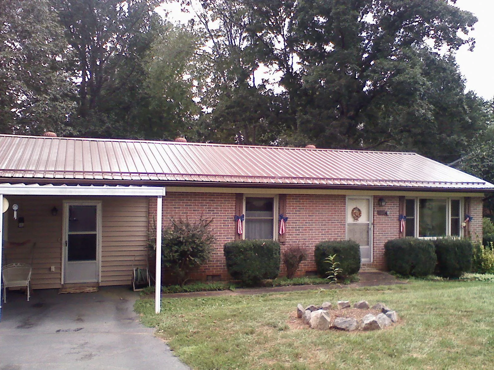 Bronze metal roof and carport on a brick ranch home — Roof Repair work by our crew in Santaquin