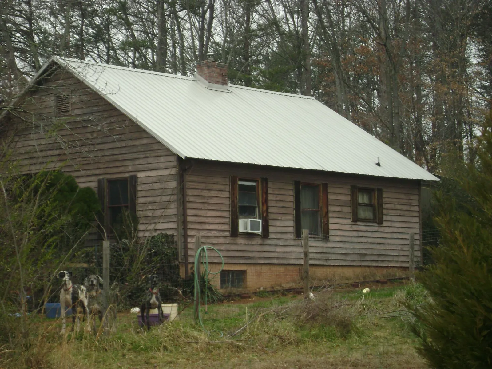 White metal roof on an old wood sided farmhouse, from a Metal Roof Installation job in Santaquin